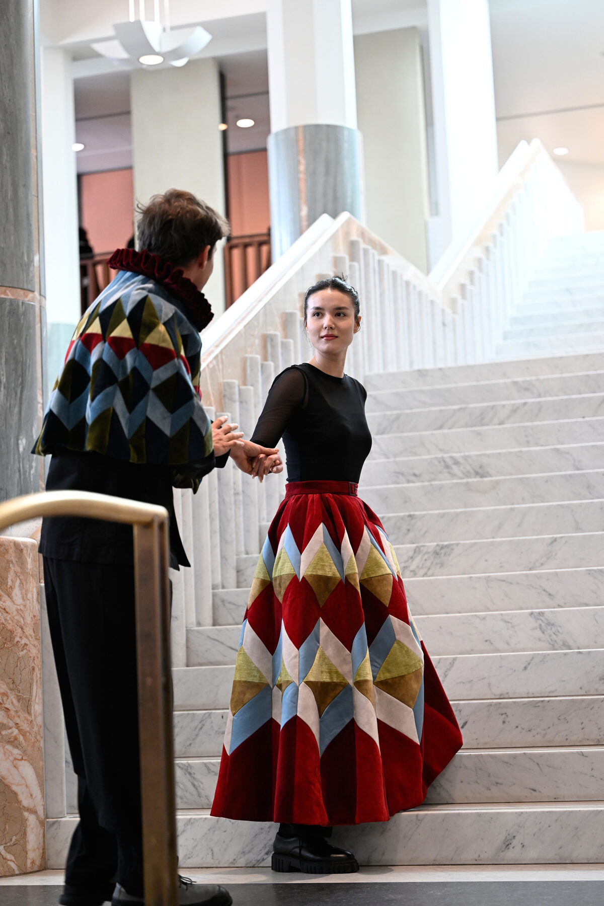 Bell Shakespeare performers in costume on the marble staircase at Parliament House, Canberra